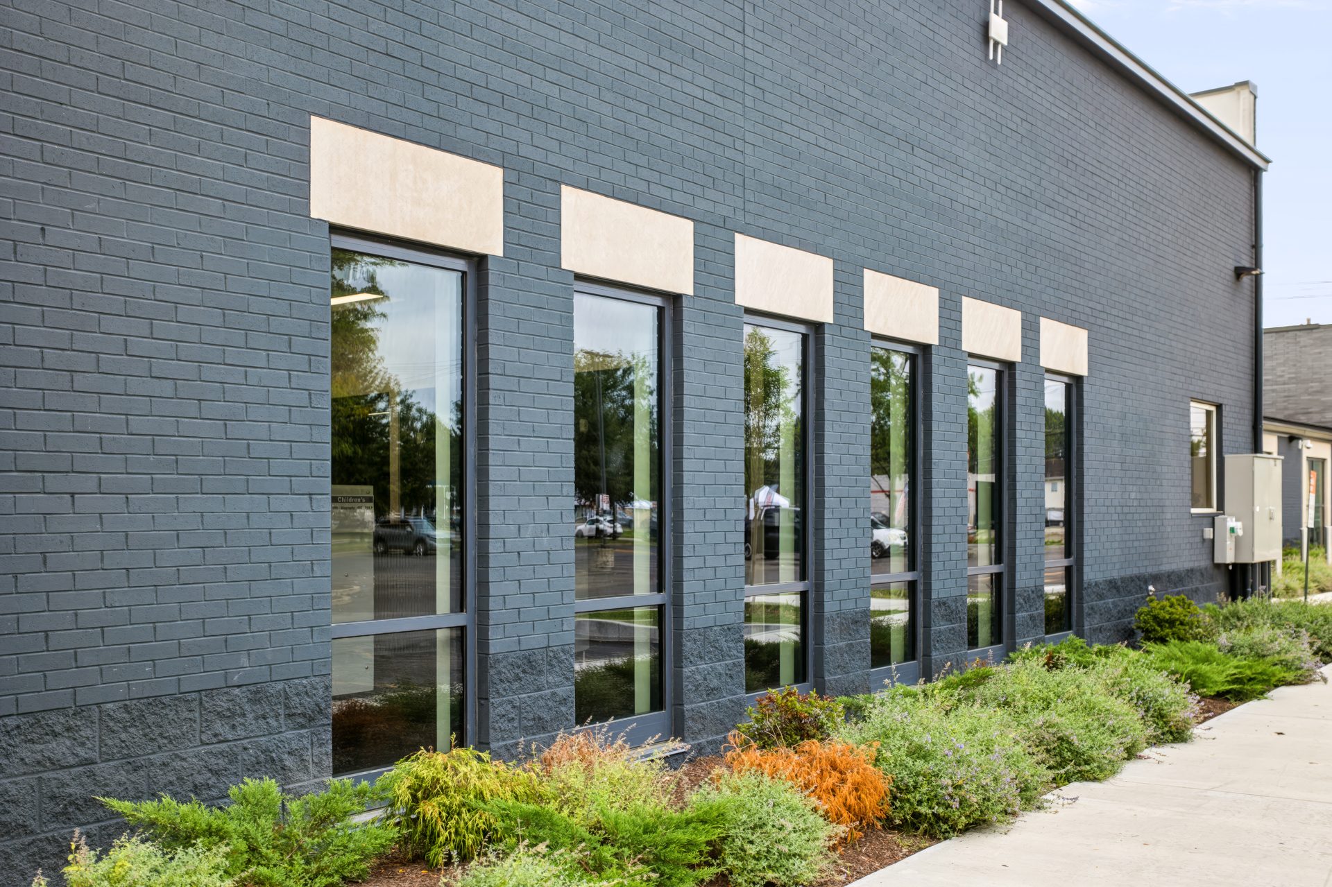 New YKK storefront windows installed in the renovated existing brick wall at the Barnett Branch library, charcoal finish